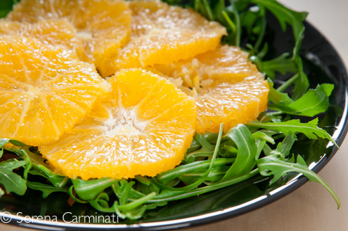 Steamed salmon with rocket and oranges (front view, rocket or arugula with oranges)