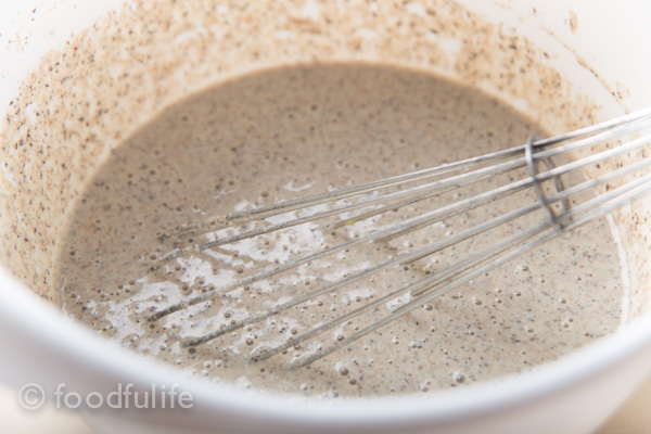 crepes batter with whisk in white plastic bowl 
